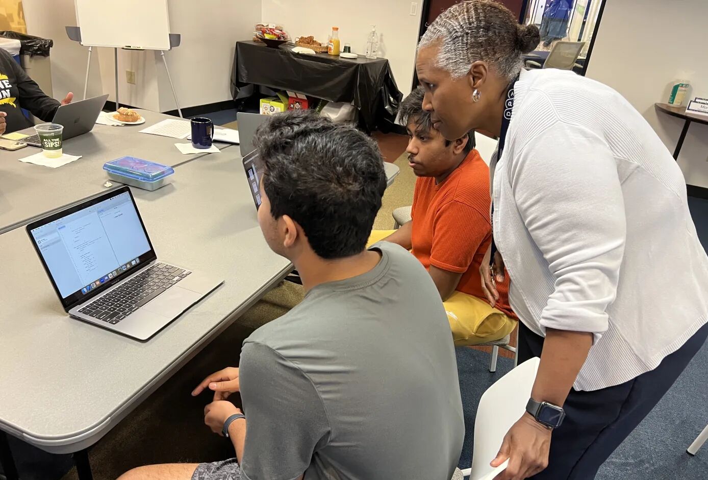 teacher with students at computer