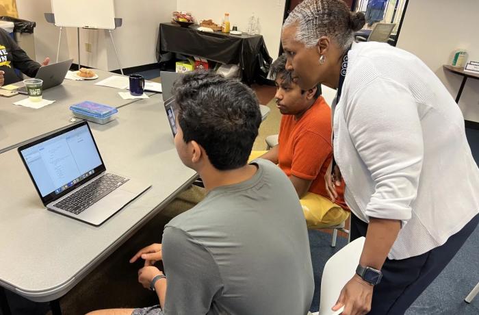 teacher with students at computer