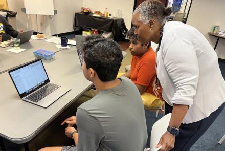 teacher with students at computer